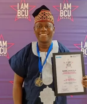 Daniel Akintola poses with his award/IAMBCU