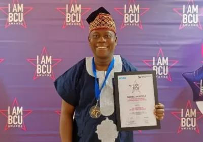 Daniel Akintola poses with his award/IAMBCU