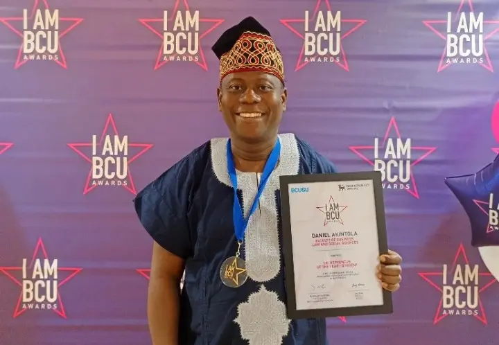 Daniel Akintola poses with his award/IAMBCU