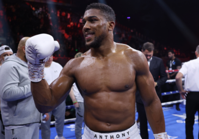 Anthony Joshua celebrates a win in the ring/Sporting News