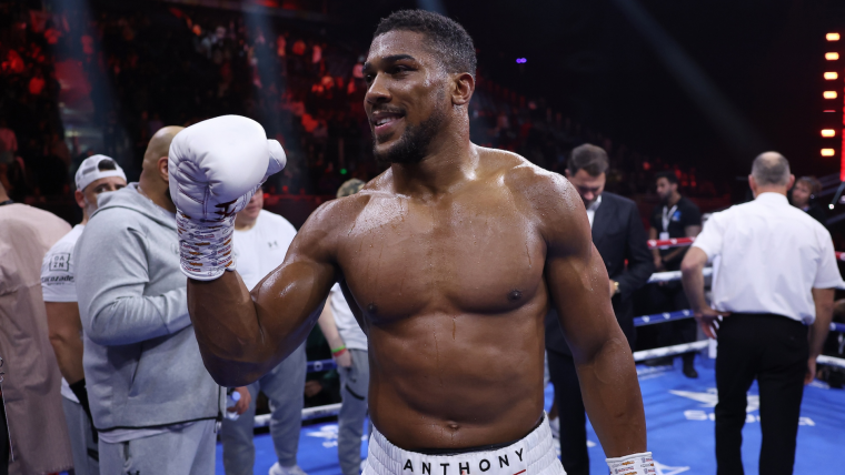 Anthony Joshua celebrates a win in the ring/Sporting News